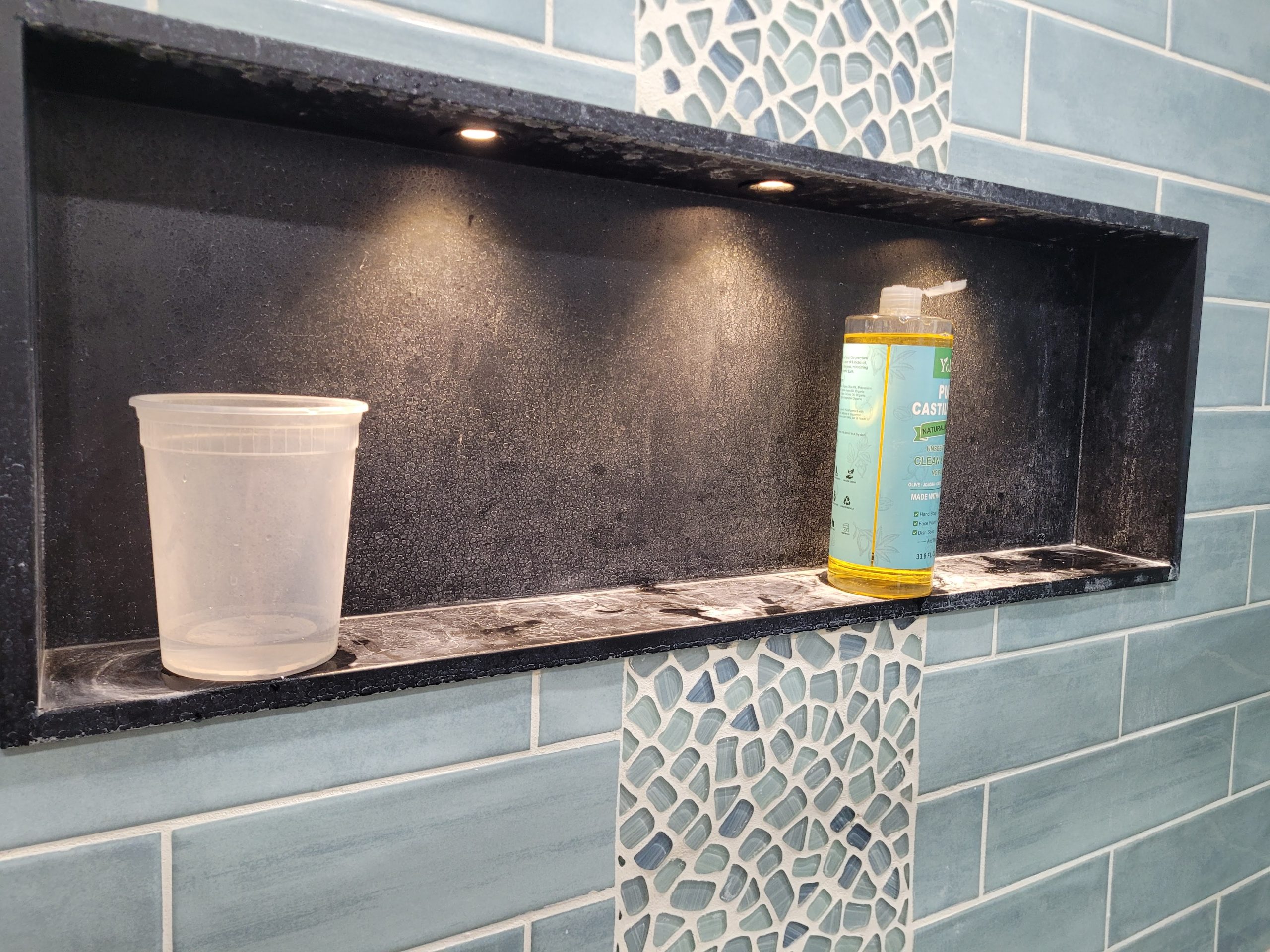 Tiled shower niche shelf installed in custom bathroom remodel Built-In Shower Shelf in Custom Bathroom Remodel